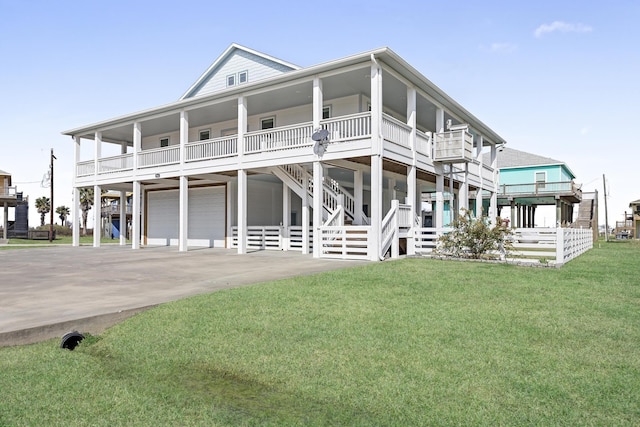 view of front of house with a front yard, a porch, and a garage