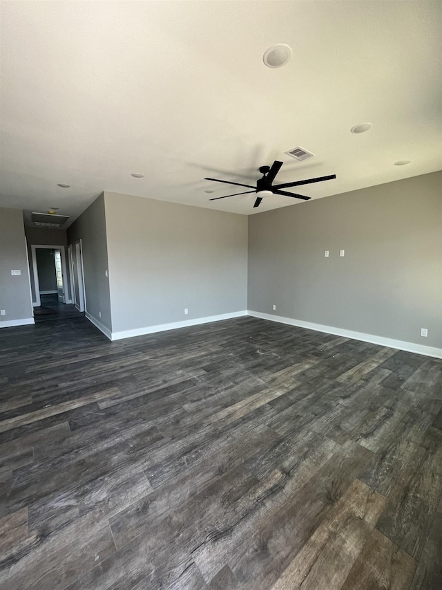 unfurnished room with ceiling fan and dark wood-type flooring