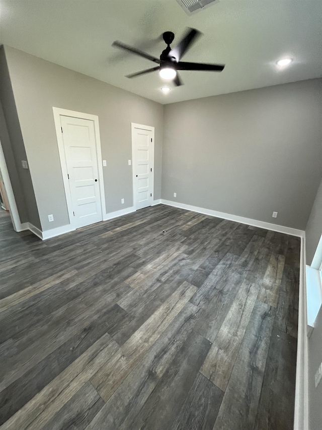 unfurnished bedroom featuring dark hardwood / wood-style flooring and ceiling fan