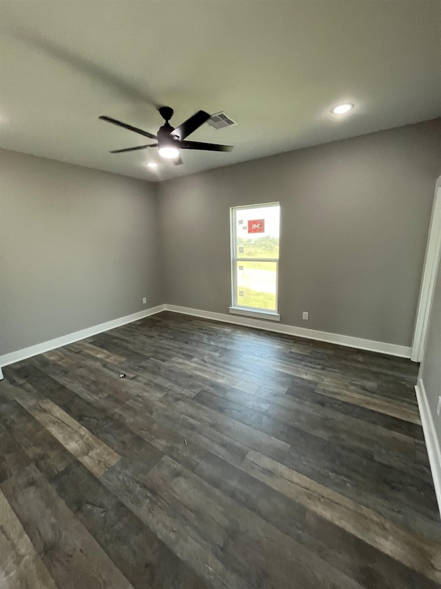 unfurnished room with ceiling fan and dark wood-type flooring