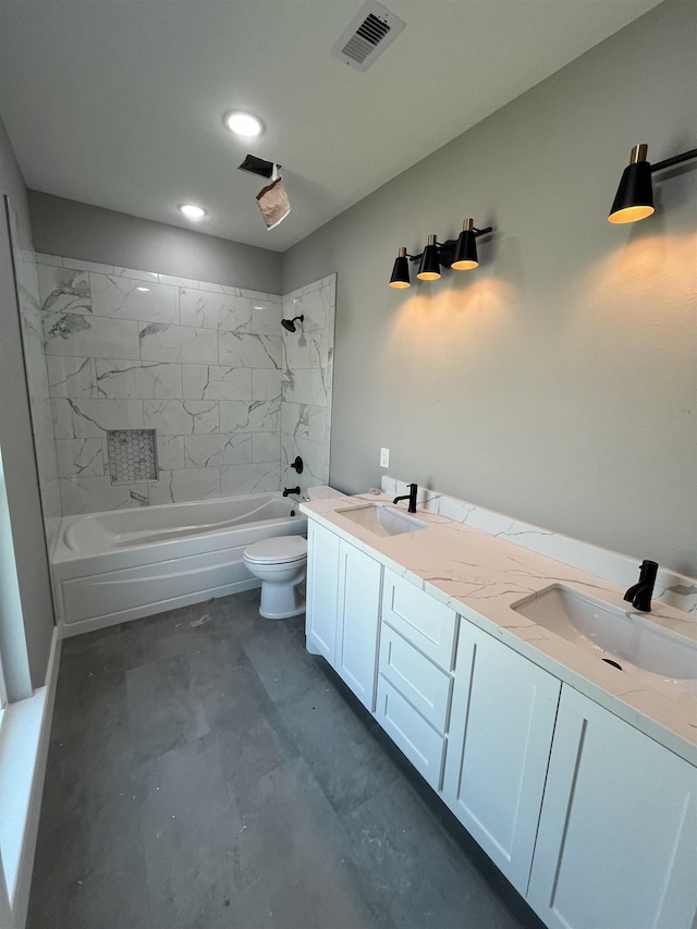 full bathroom featuring vanity, toilet, concrete flooring, and tiled shower / bath combo