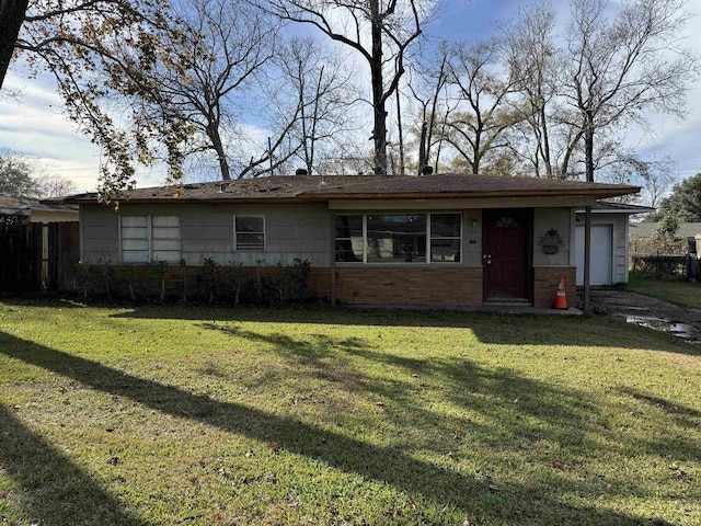 ranch-style house with a garage and a front lawn