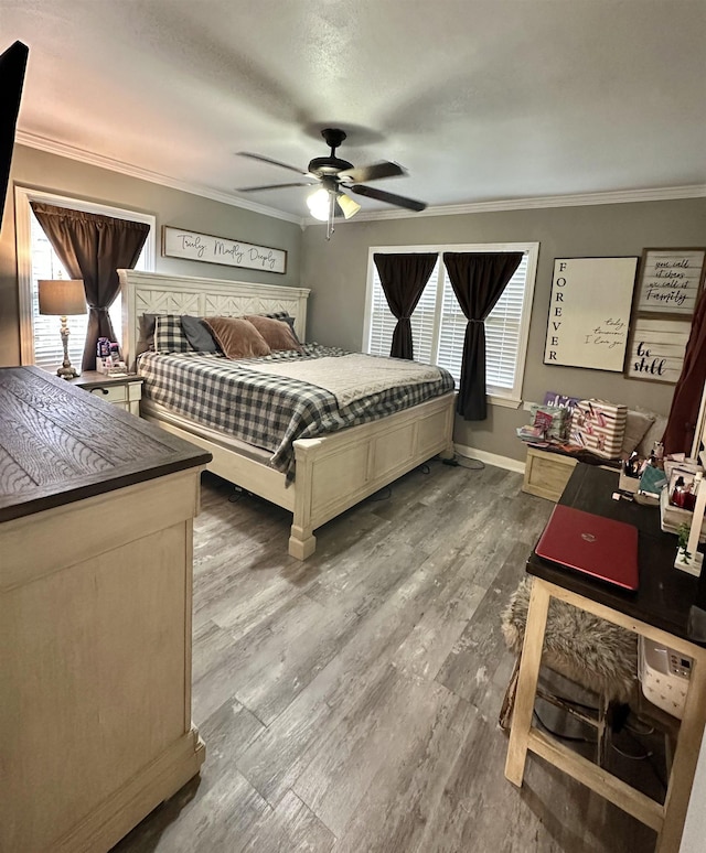 bedroom with ceiling fan, crown molding, wood-type flooring, and a textured ceiling