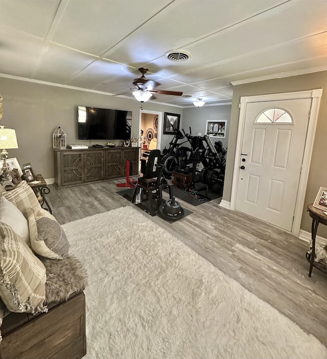 exercise area featuring hardwood / wood-style flooring and ceiling fan