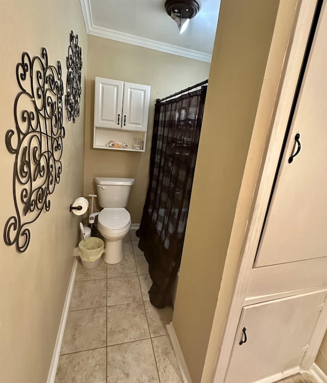 bathroom with tile patterned flooring, toilet, and crown molding