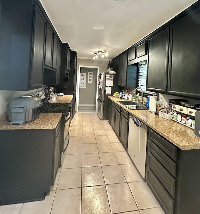 kitchen featuring light stone countertops, light tile patterned floors, sink, and appliances with stainless steel finishes