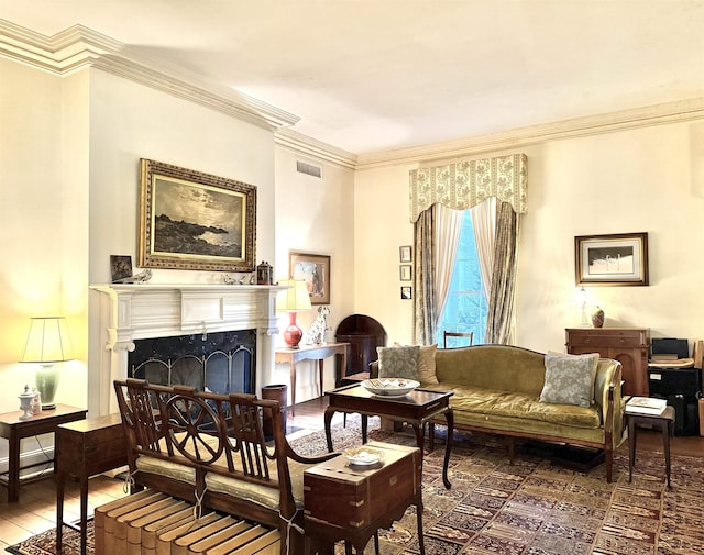 living area featuring hardwood / wood-style floors and ornamental molding