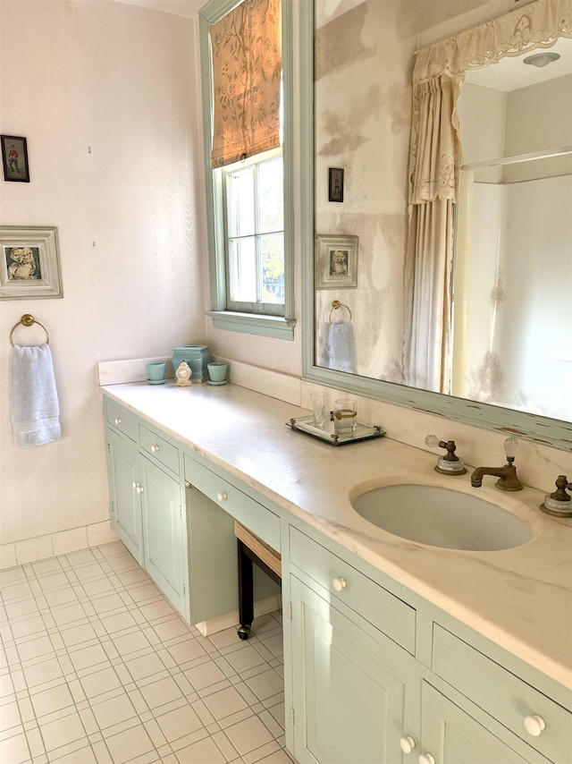 bathroom featuring tile patterned flooring and vanity