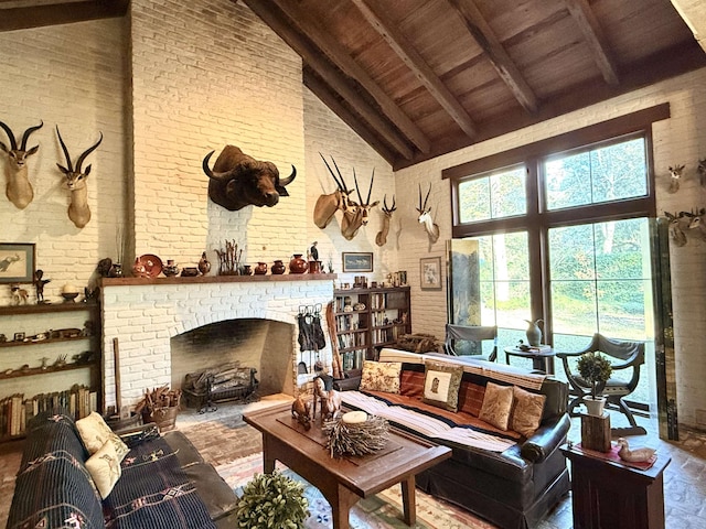 living room with beamed ceiling, high vaulted ceiling, brick wall, and a brick fireplace