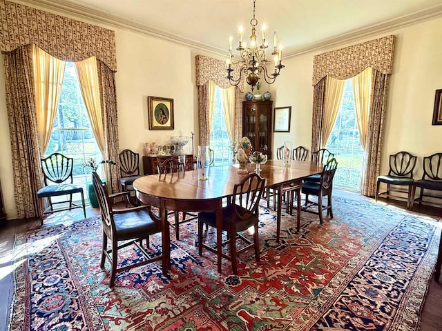 dining space featuring a notable chandelier, crown molding, and a wealth of natural light