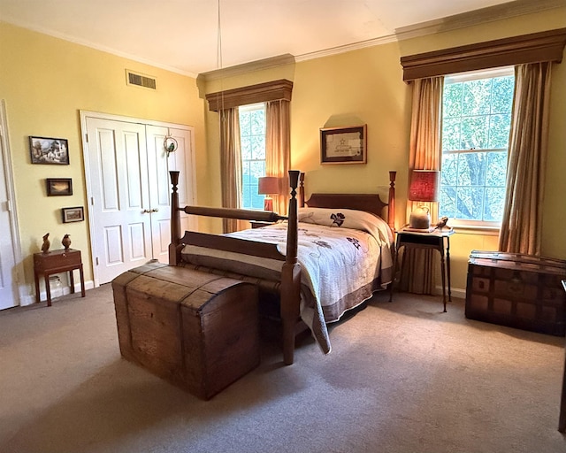 carpeted bedroom featuring ornamental molding, multiple windows, and a closet