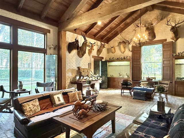 living room with beam ceiling, wooden ceiling, high vaulted ceiling, and a chandelier