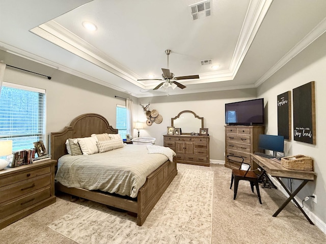 bedroom featuring ornamental molding, a raised ceiling, and multiple windows