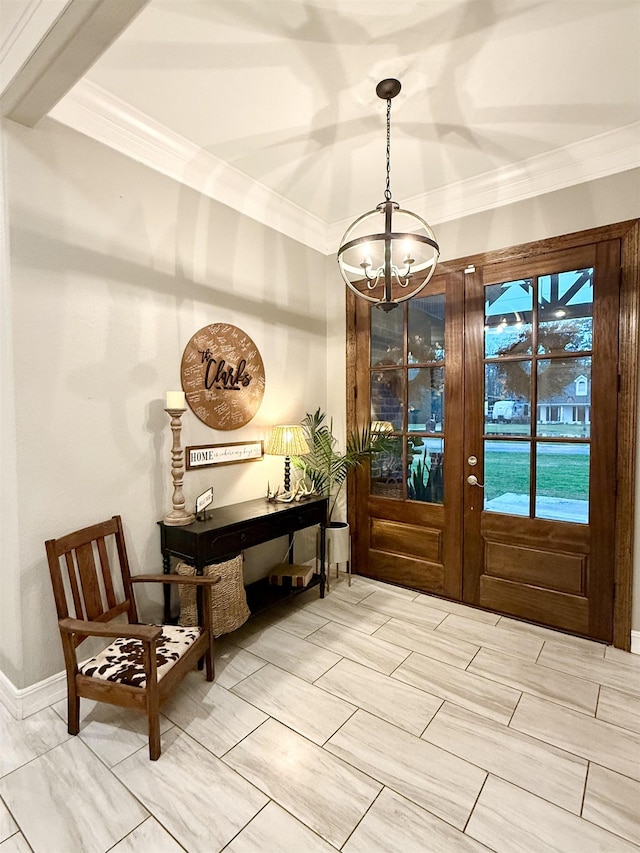 entryway with crown molding and a notable chandelier