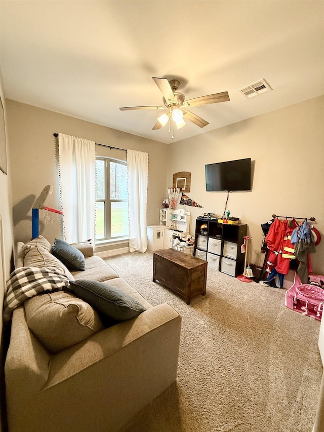 carpeted living room with ceiling fan