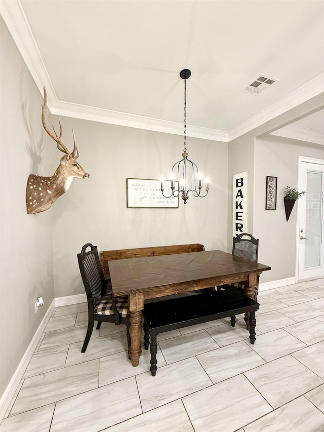 dining space with ornamental molding and a chandelier