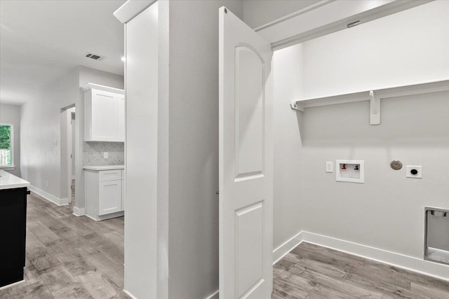 washroom with electric dryer hookup, hookup for a gas dryer, light wood-type flooring, and hookup for a washing machine