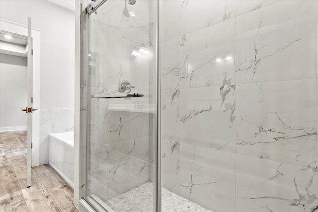 bathroom with wood-type flooring and plus walk in shower