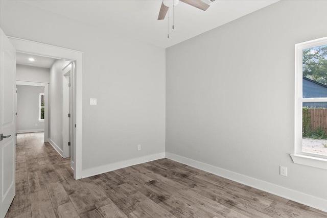 empty room with hardwood / wood-style flooring and ceiling fan