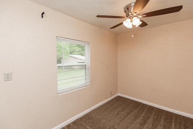 unfurnished room featuring a textured ceiling, ceiling fan, baseboards, and dark colored carpet