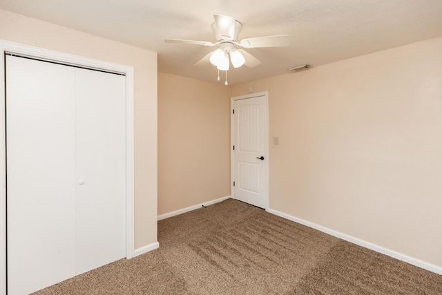unfurnished bedroom with a ceiling fan, visible vents, baseboards, a closet, and carpet