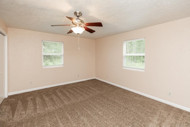 unfurnished room featuring carpet flooring, a textured ceiling, and ceiling fan