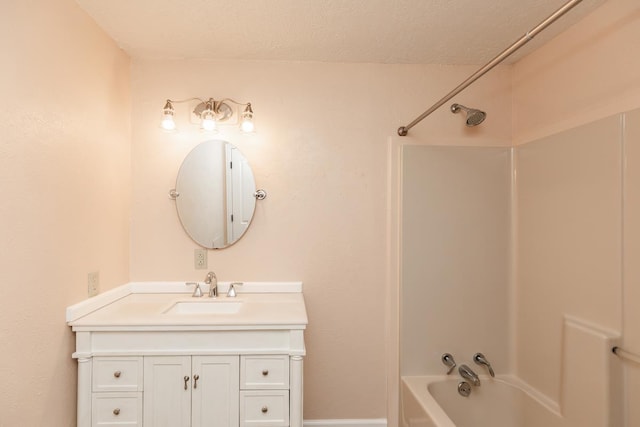 bathroom featuring vanity and  shower combination