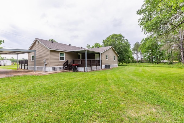 rear view of property with a lawn and cooling unit