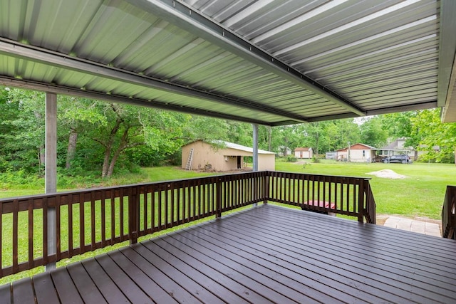 wooden deck with a lawn and an outdoor structure