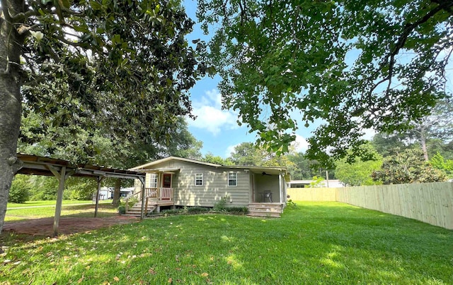 rear view of property with a lawn