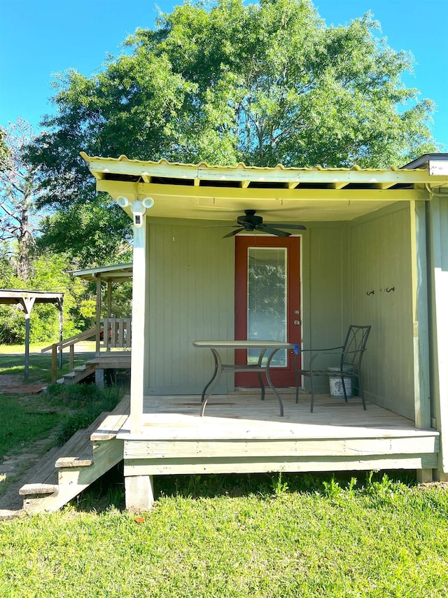 exterior space with ceiling fan and a wooden deck