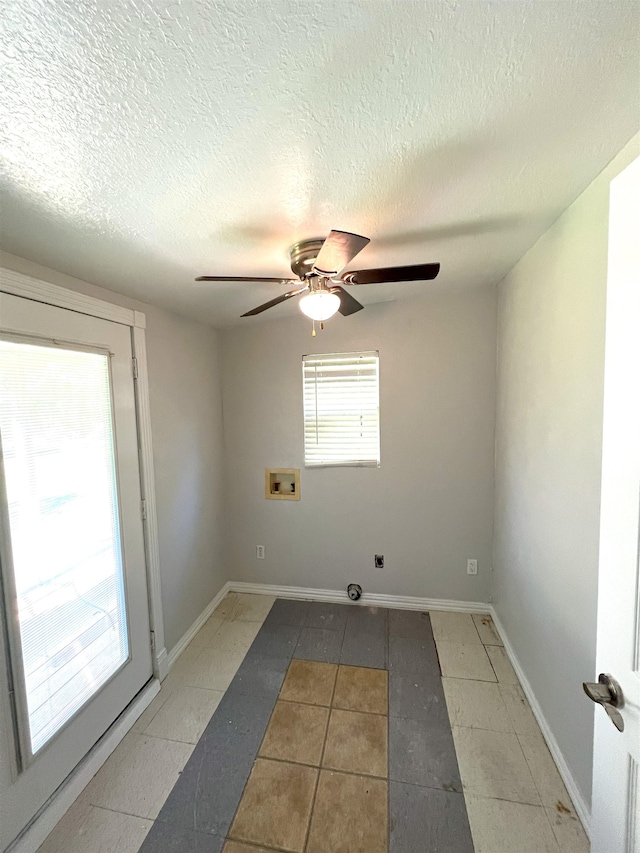 spare room featuring ceiling fan and a textured ceiling