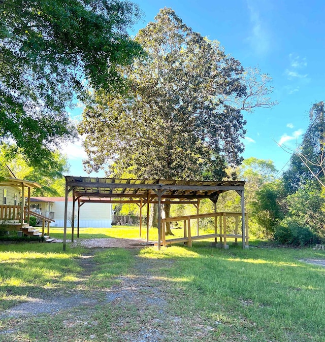 view of property's community featuring a pergola and a yard