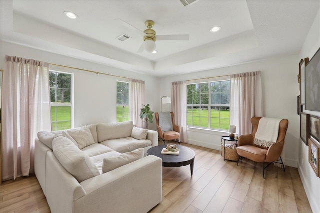 11109 County Road 701, Buna, TX 77612 - living room with a raised ceiling, a ceiling fan, light wood-style floors, baseboards, and recessed lighting