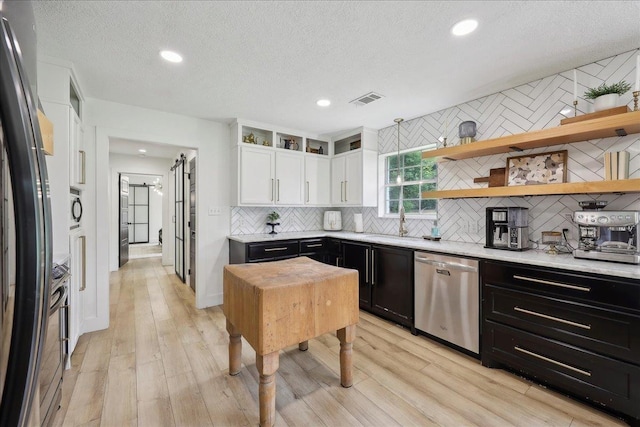 11109 County Road 701, Buna, TX 77612 - kitchen with dishwasher, white cabinets, open shelves, tasteful backsplash, and recessed lighting