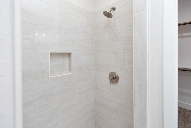 bathroom with a tile shower