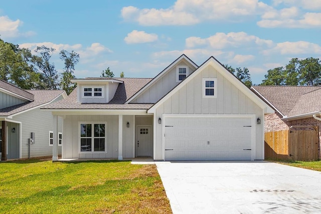 view of front of property with a porch, a garage, and a front yard