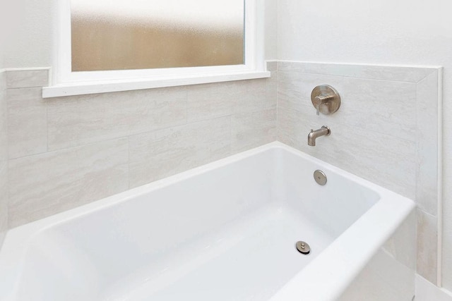 bathroom featuring a tub to relax in