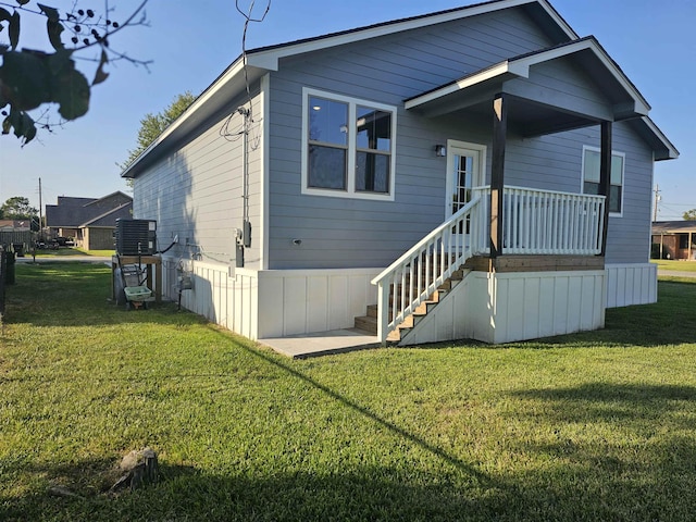 view of front of home with central air condition unit and a front lawn