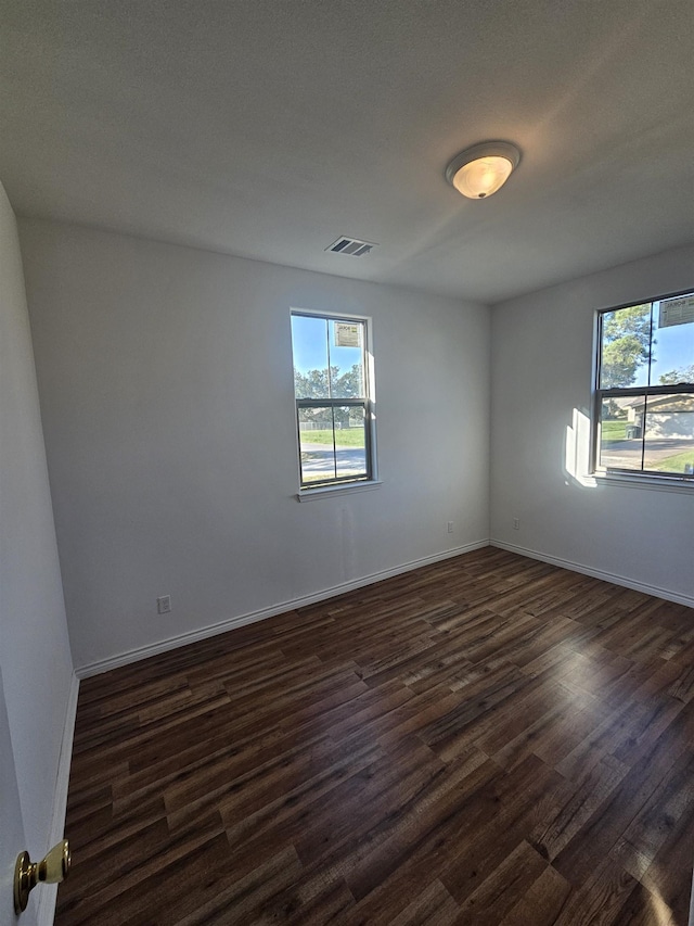 unfurnished room with dark hardwood / wood-style floors