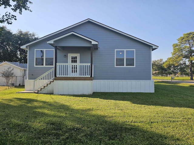 rear view of property with a lawn