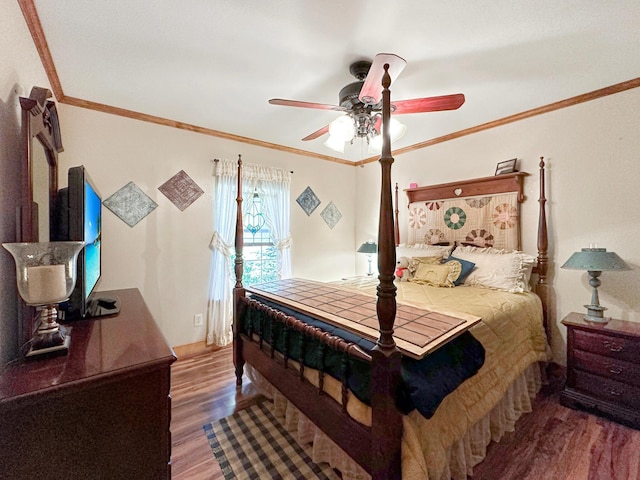 bedroom featuring hardwood / wood-style flooring, ceiling fan, and ornamental molding