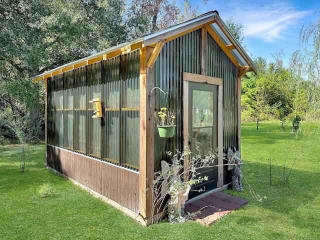 view of outbuilding featuring a lawn