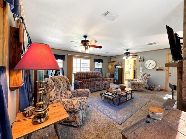 living room featuring carpet flooring, ceiling fan, and crown molding