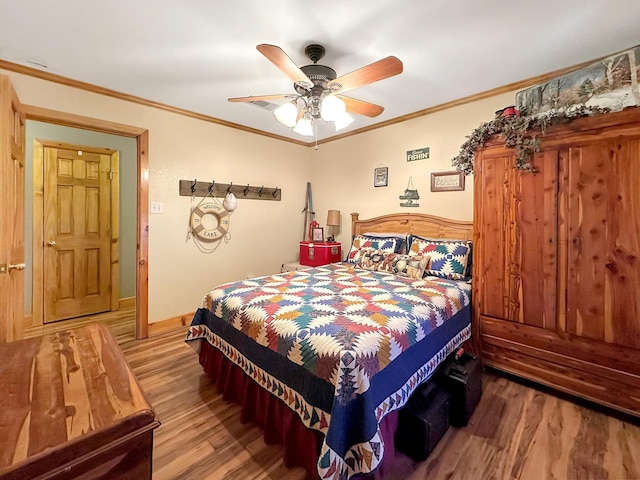 bedroom featuring ceiling fan, crown molding, and wood-type flooring