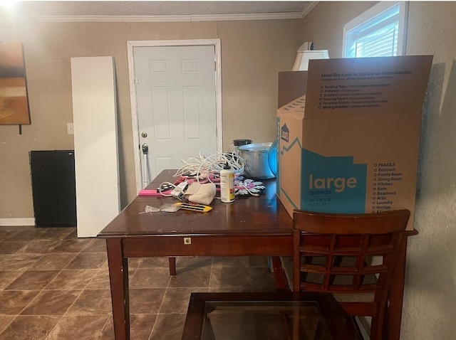 dining area featuring crown molding