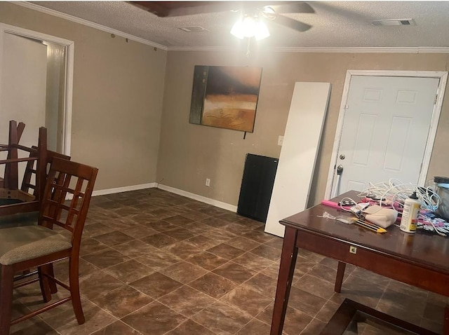 interior space featuring ceiling fan, a textured ceiling, and ornamental molding