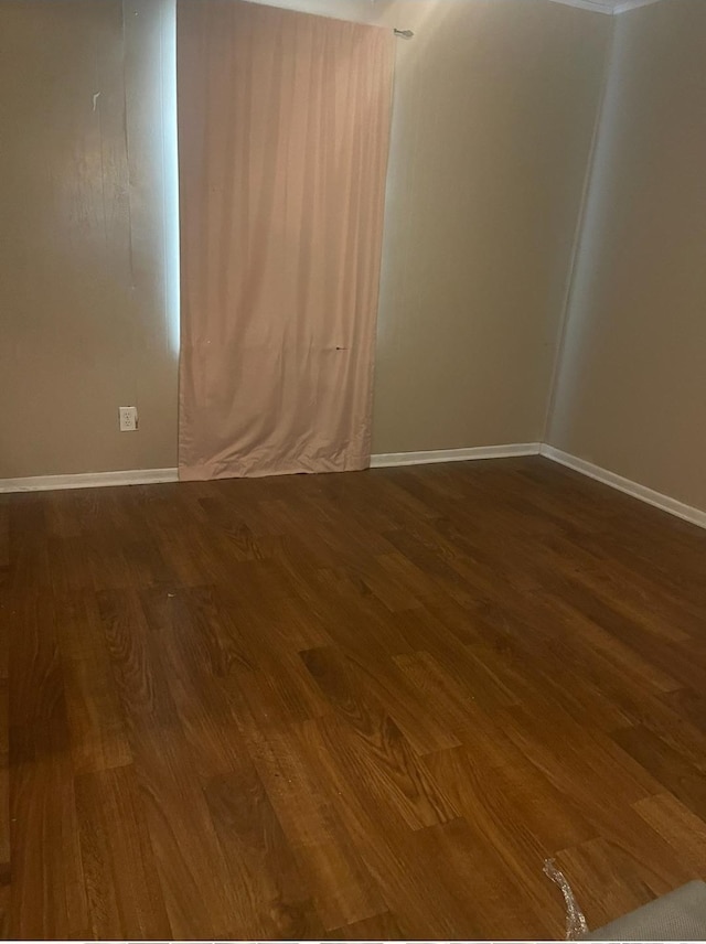 spare room featuring wood-type flooring