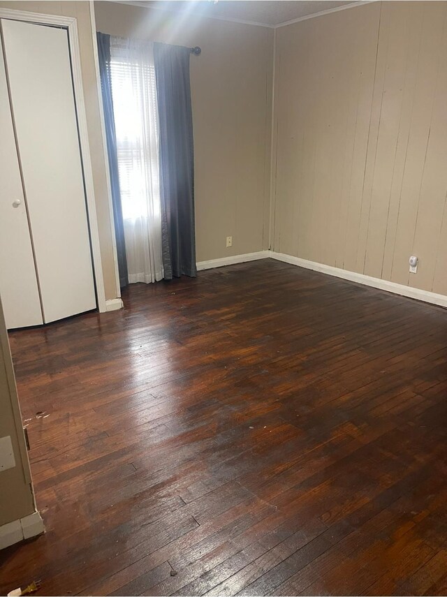 unfurnished bedroom with dark hardwood / wood-style flooring