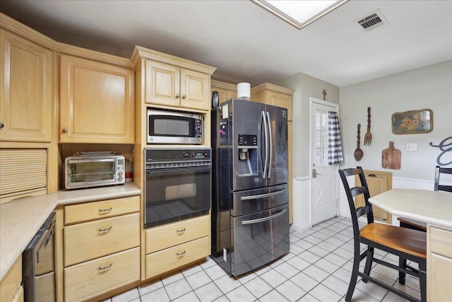 132 County Road 760, Buna, TX 77612 - kitchen featuring light brown cabinetry, a toaster, stainless steel appliances, light countertops, and visible vents